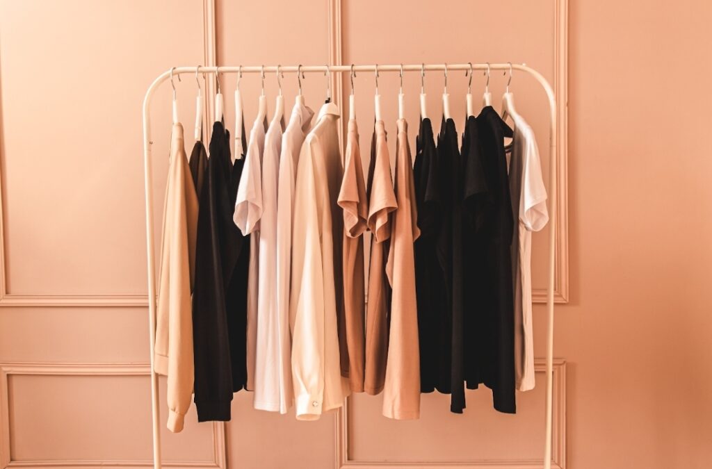 A curated rail of stylish neutral clothes