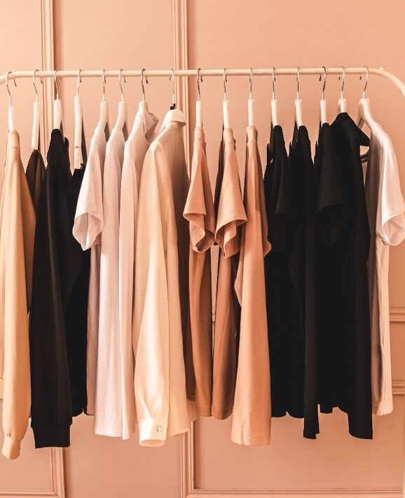 A curated rail of stylish neutral clothes