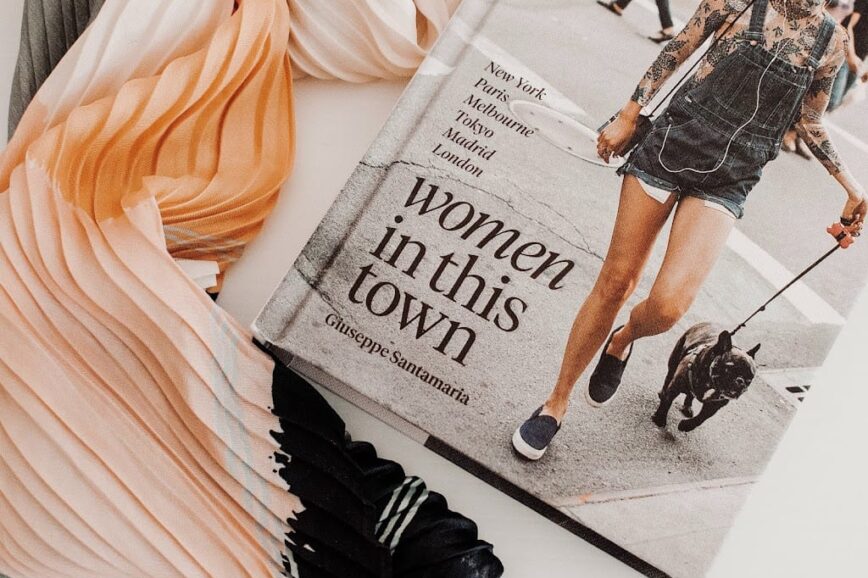 Flat lay photograph featuring a copy of vogue magazine and a soft chiffon scarf in neutral tones