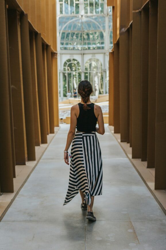 Brunette author walking along a corridoe of light
